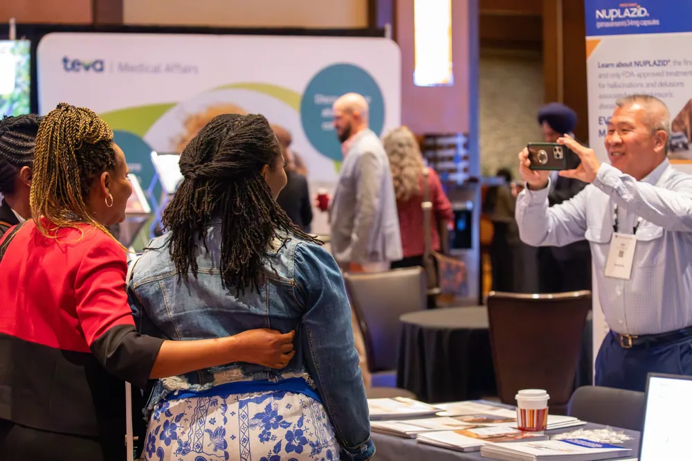 Attendees taking a photo in the exhibit hall at NEI Spring Congress